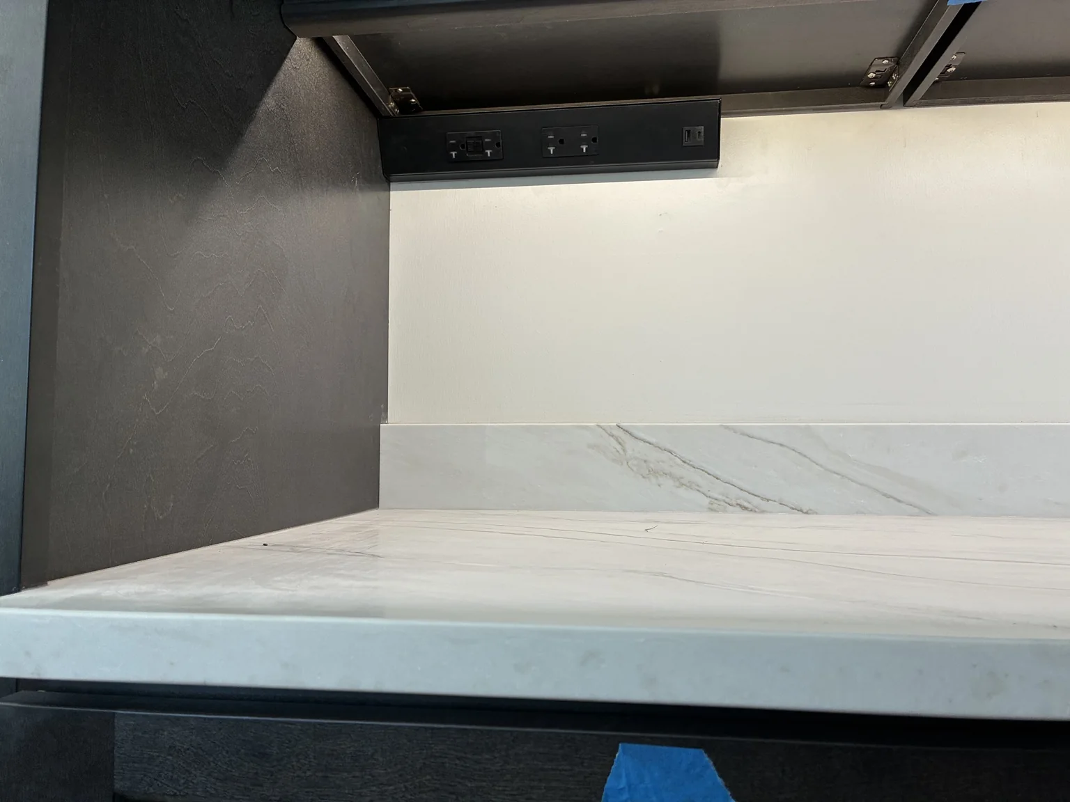 Under-cabinet lighting and hidden outlets