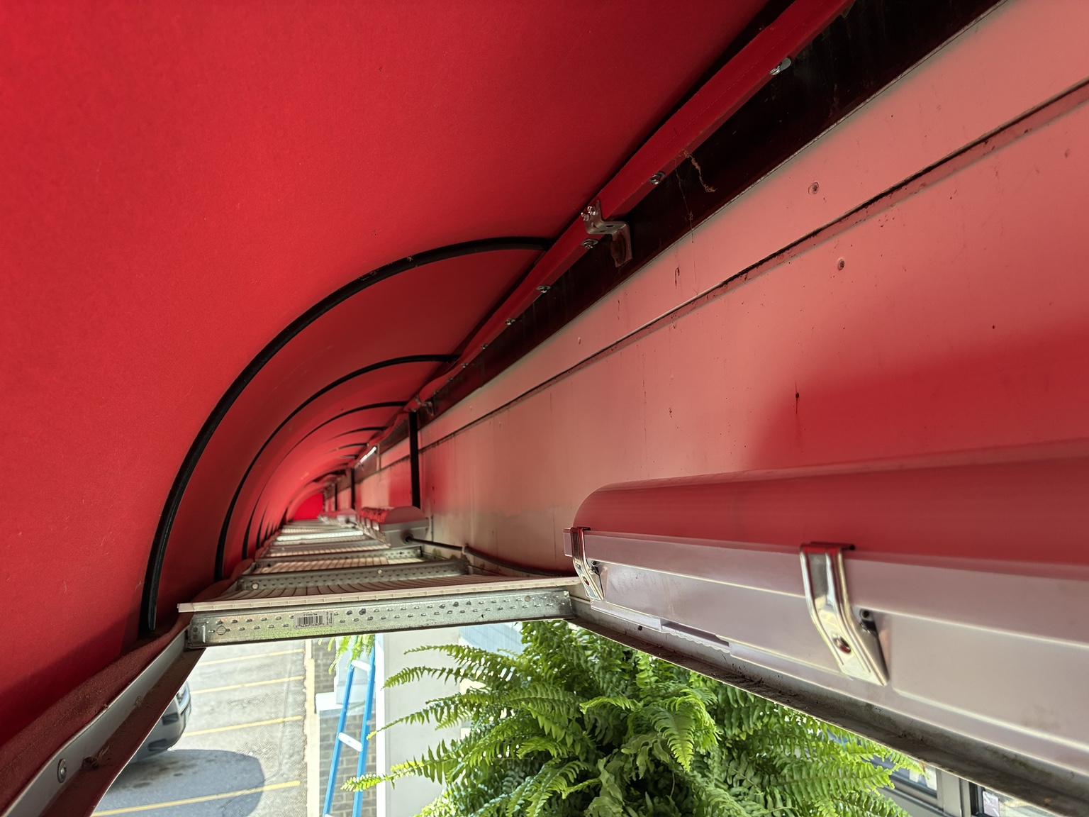 Weather-resistant linear LED fixture installed under commercial awning