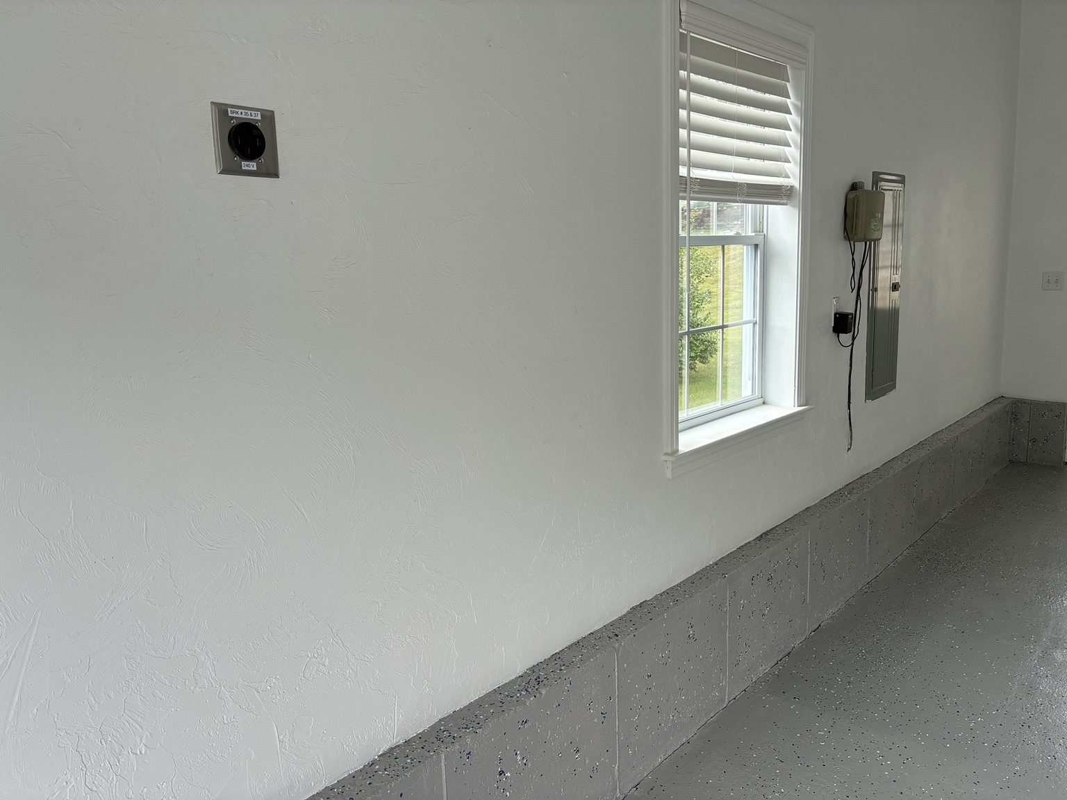 Garage prepared for Level 2 EV charging with 240V NEMA 14-50 receptacle