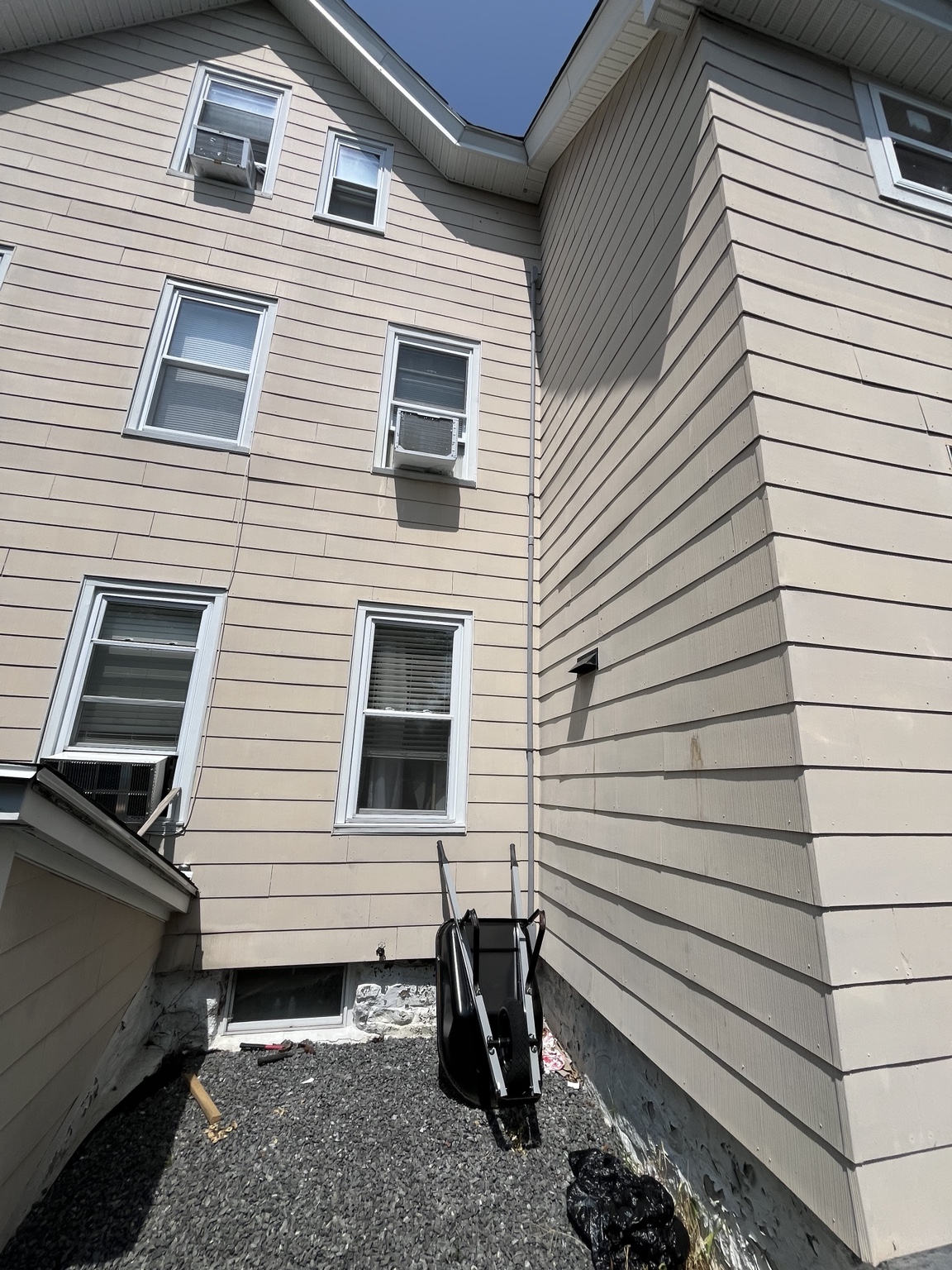 Exterior view of home with third-floor electrical work